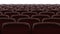 Moving behind the chairs in abstract cinema hall with white screen seamless. Looped 3d animation of rows of seats in