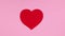 Moving big red valentine`s day heart on pink theme. Stop motion