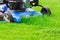 Moving Blue Lawnmover Cutting Green Grass