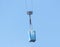 Moving a blue porta-potty through the air