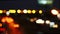 Moving bokeh circles from the lights of cars running on the city streets. City blur background.  Night traffic.