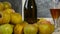 Moving camera slider showing bottle and glasses of cider with apples. In rustic house