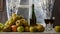 Moving camera slider showing bottle and glasses of cider with apples. In rustic house