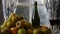 Moving camera slider showing bottle and glasses of cider with apples. In rustic house