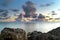 Moving clouds above large lake with smooth water and a sunset view from the coast