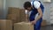 Moving company worker carefully packing and carrying boxes, quality services