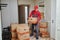Moving or delivery service. Mover worker carrying cardboard boxes into home