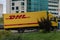 A moving DHL truck, courier service delivers parcels to customers, courier company , international express mail services. online