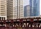 Moving elevated el train, part of Chicago`s iconic transit system, crosses Wells Street bridge over the Chicago River in the Loop