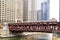 Moving elevated el train, part of Chicago`s iconic transit system, passing over Chicago River