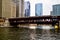 Moving elevated el train, part of Chicago`s iconic transit system, passing over Chicago River