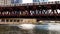 Moving elevated el train, part of Chicago`s iconic transit system, passing over Chicago River where Water Taxi transports commuter