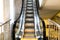 moving escalator with yellow electric backlight