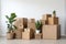 Moving essentials: cardboard collections and a lively plant by a spotless background