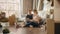 Moving in: Happy Young Homeowners: Couple Sitting on the Floor of their New Apartment Use Laptop