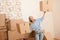 Moving house: Woman holding big carton box