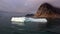 Moving Ice Floes on background of mountain on water of Arctic Ocean in Svalbard.