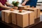 Moving in joy: Couple\\\'s hands hold boxes in close-up, marking their home transition.