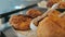 Moving panning right shot of many sweet crispy croissants and rugelach placed on a tray in a cafe or bakery shop