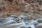 Moving river in red rock canyon, Zion National Park, Utah