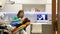 A moving shot in a dentists office, a young female dentist examining and working on the patients teeth