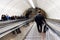 Moving Staircase Escalator Inside the Underground Metro Station. People climbing the steps of the escalator. Underground subway