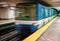 Moving subway train with an empty subway platform.