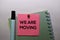 We Are Moving text on sticky notes isolated on office desk