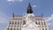 Moving tilt up view around monument in front of Hungarian Parliament Building in sunny day