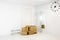 Moving to a new home concept. Pile of cardboard boxes in white minimalist white home hallway. Waiting to be moved. Lot of room for