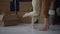 Moving to a new house or apartment, real estate concept. Close-up of the bare feet of an unrecognizable husband and wife