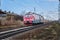 A moving train through the countryside. Railroad with train. Spring, day. View from the front.