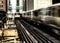 Moving Train on elevated tracks within buildings at the Loop, Glass and Steel bridge between buildings - Chicago City Center - Lon