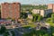 Moving transport on circle crossroad in Mikroraion in sunny summer day. Cityscape from