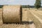 Mowed straw on an empty field. Round sheaves of straw on the stu