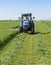 Mowing clover field with rotary cutter