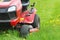 Mowing or cutting the long grass with a lawn mower . Gardening concept background