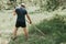 mowing the grass traditional old-fashioned way with the hand scythe on the household village farm