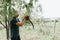 mowing grass traditional old-fashioned way with hand scythe on household village farm. young mature farmer man