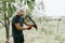 mowing grass traditional old-fashioned way with hand scythe on household village farm. young mature farmer man