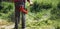 Mowing trimmer - worker cutting grass closeup