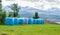 Mown hay packed in pink and blue polyethylene bales on the field