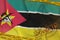 Mozambique flag and Covid-19 biohazard symbol with quarantine orange tape and stamp. Coronavirus or 2019-nCov virus concept