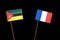 Mozambique flag with French flag isolated on black