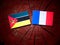 Mozambique flag with French flag on a tree stump isolated