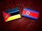 Mozambique flag with North Korean flag on a tree stump