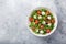 Mozarella, tomato and arugula salad in whute bowl