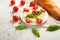 Mozzarella with basil leaves - fresh ingredients for Bruschetta, with cherry tomatoes and French baguette with copy space on a lig