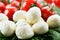 mozzarella cheese balls, ripe cherry tomatoes and greens close-up on the white background. horizontal