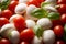 Mozzarella Cheese, Cherry Tomatoes, and Basil. Close-up of caprese salad ingredients: mini mozzarella balls, ripe whole cherry